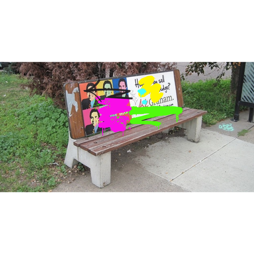 Concrete and brown park bench with graffiti over pictures on the bench